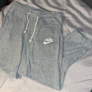 Gray Nike pants with cuffed legs. It has two pockets. No rips or stains.